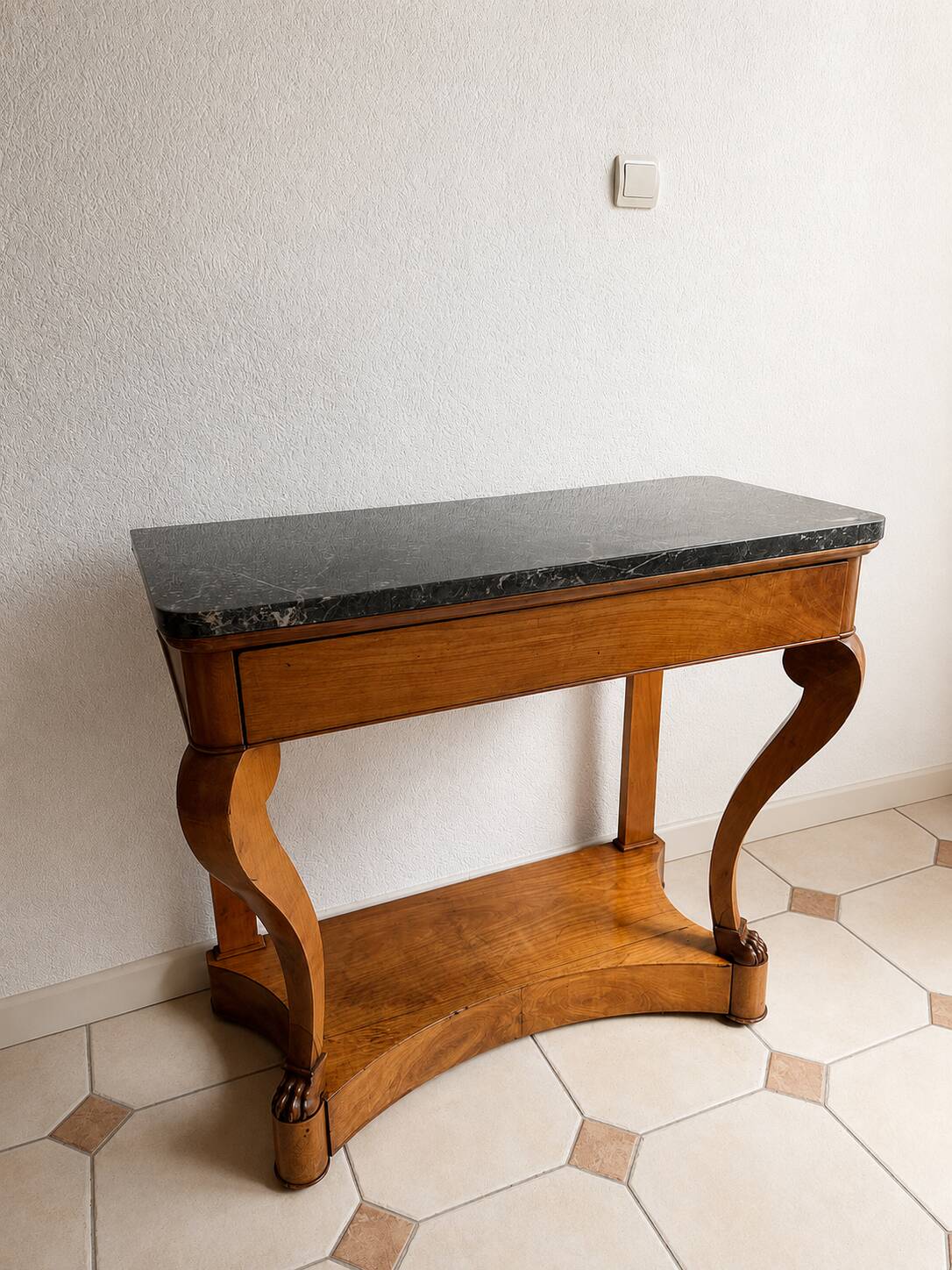 French console from the 19th century in cherry wood and black marble, with claw feet.