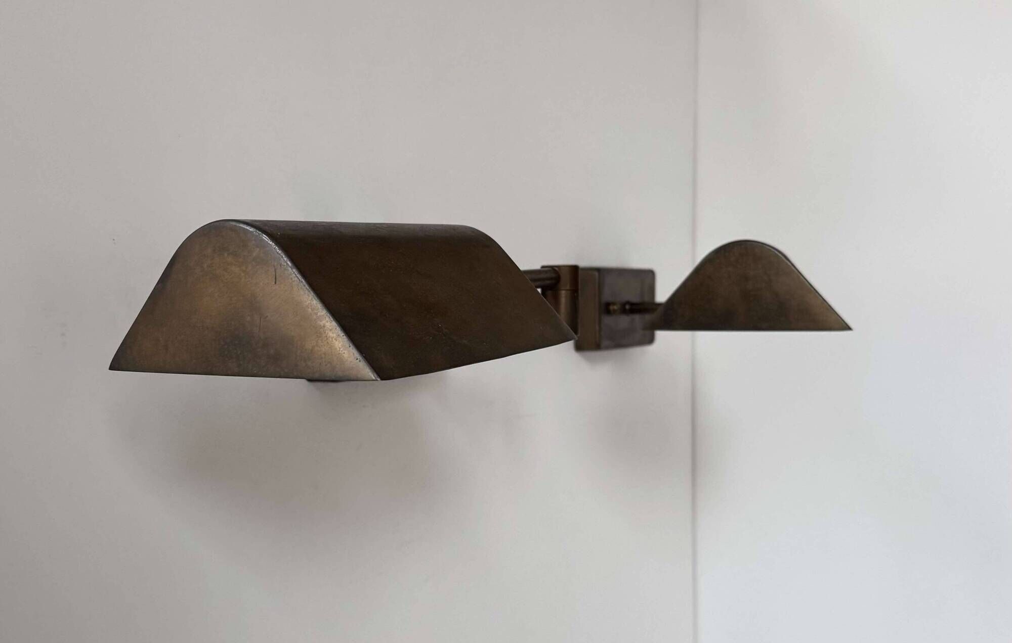 Pair of vintage adjustable wall lights, patinated brass, France 1970.