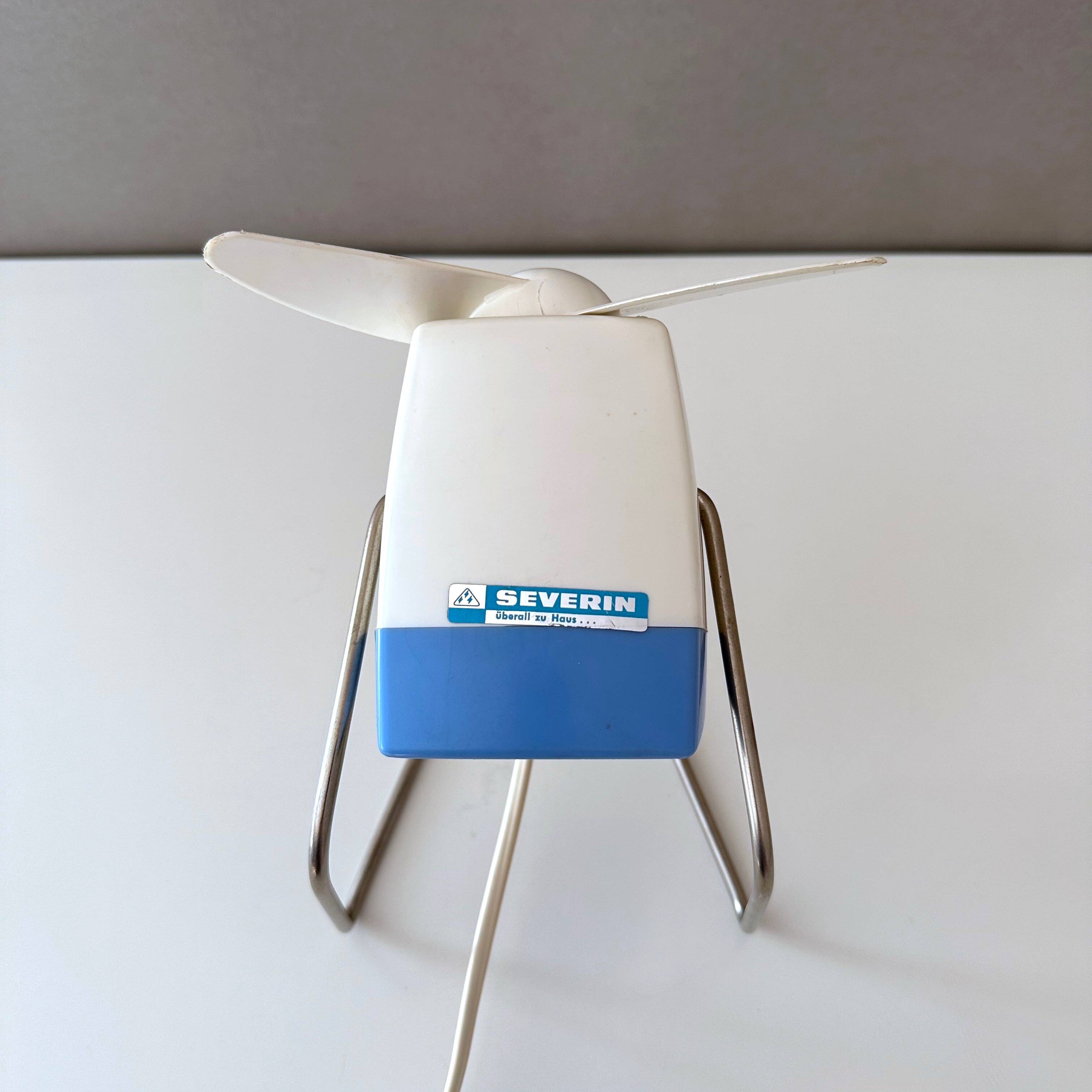 Blue Severin electric fan, mid-century office