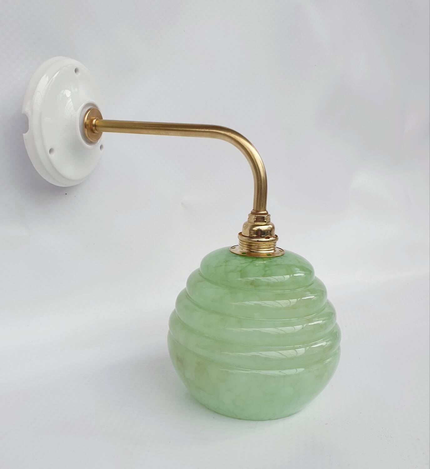 Brass collar and speckled glass wall lamp