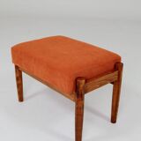 Vintage armchair and footrest in orange corduroy.