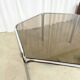 Vintage hexagonal table with smoked glass top and chrome metal structure.