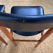 4 Scandinavian chairs in teak and black faux leather.