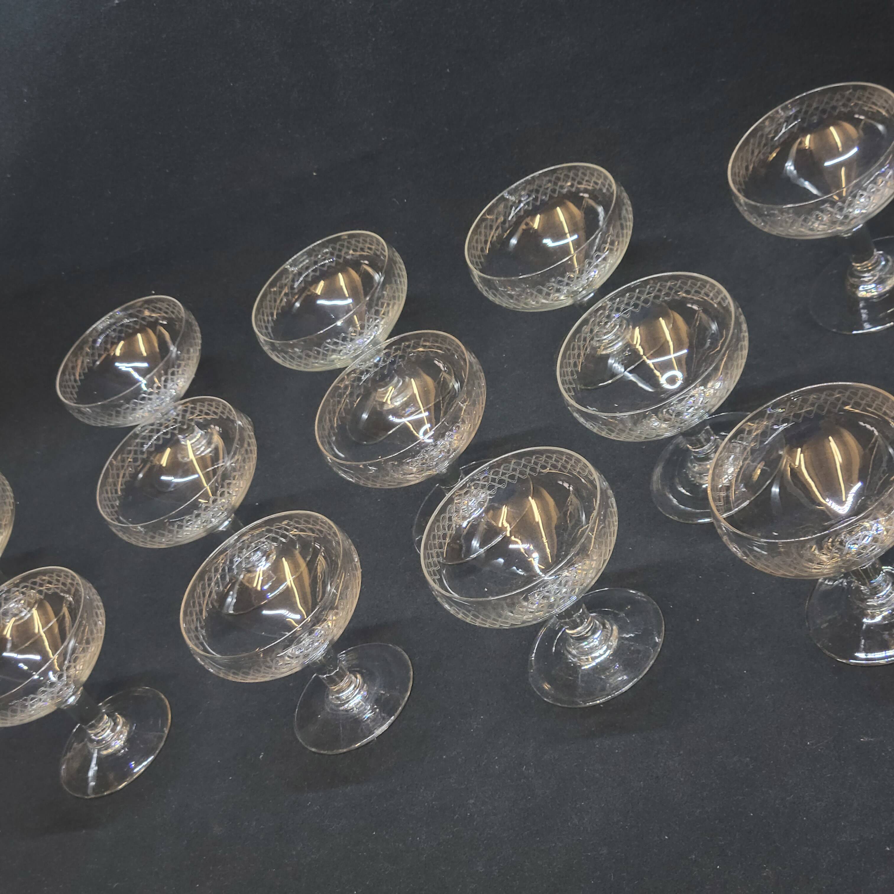 12 old champagne glasses in blown and engraved glass