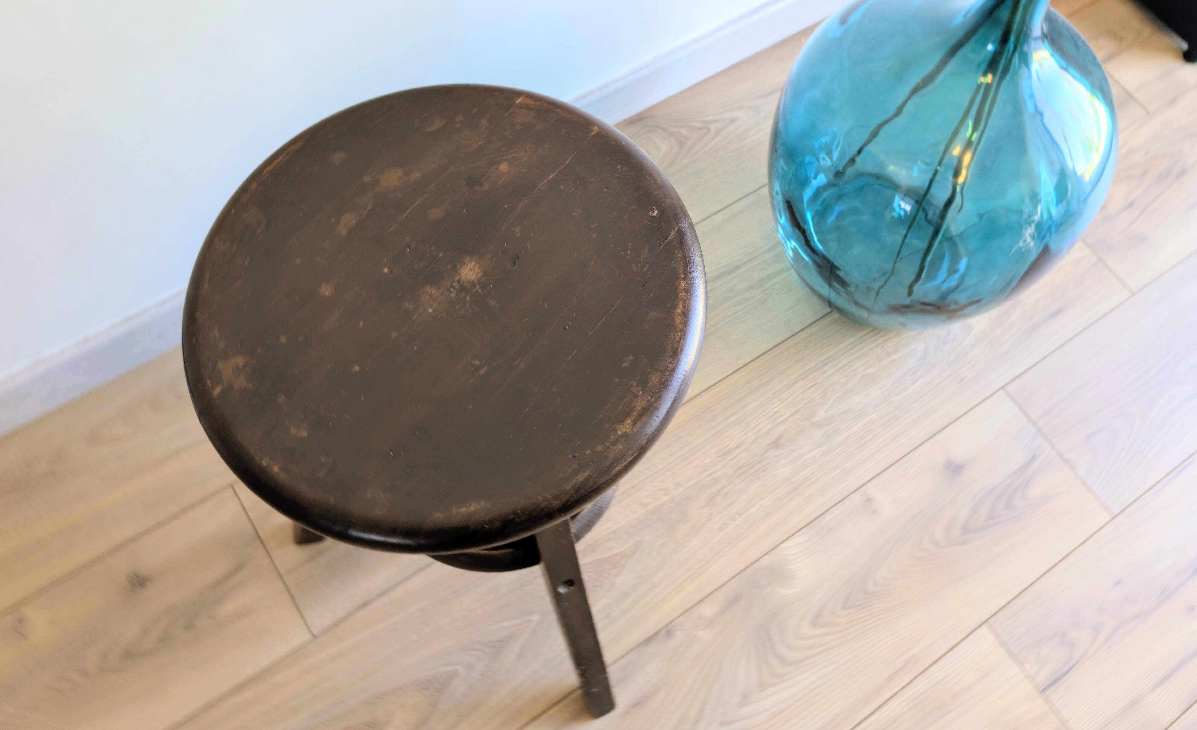 Antique wooden watchmaker's stool with screws, patinated wood.