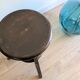 Antique wooden watchmaker's stool with screws, patinated wood.