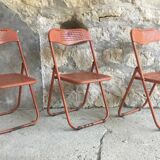 Trio of orange metal folding chairs - vintage