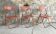 Trio of orange metal folding chairs - vintage