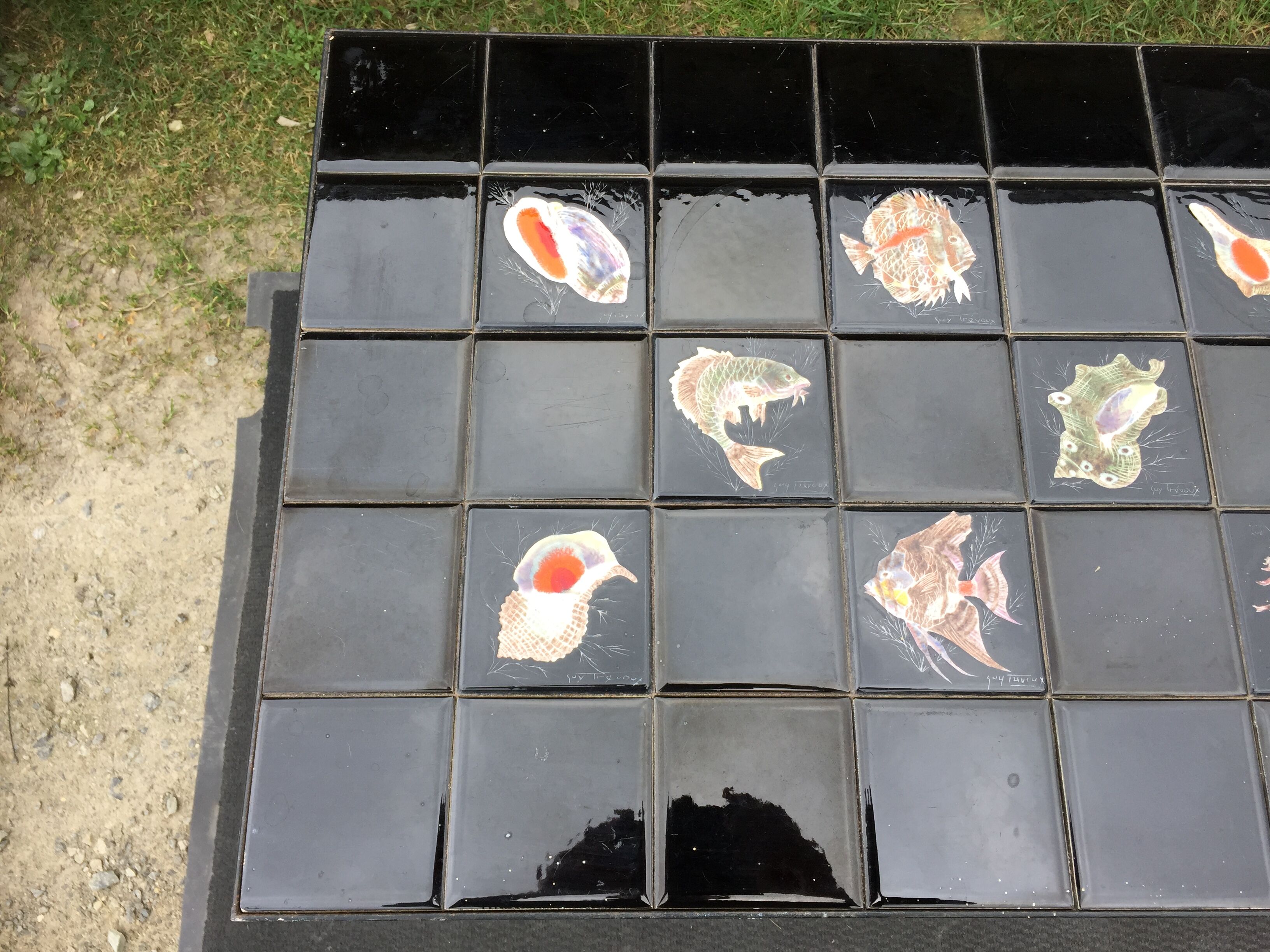 Vintage ceramic coffee table by Guy Trévoux with wrought iron base.