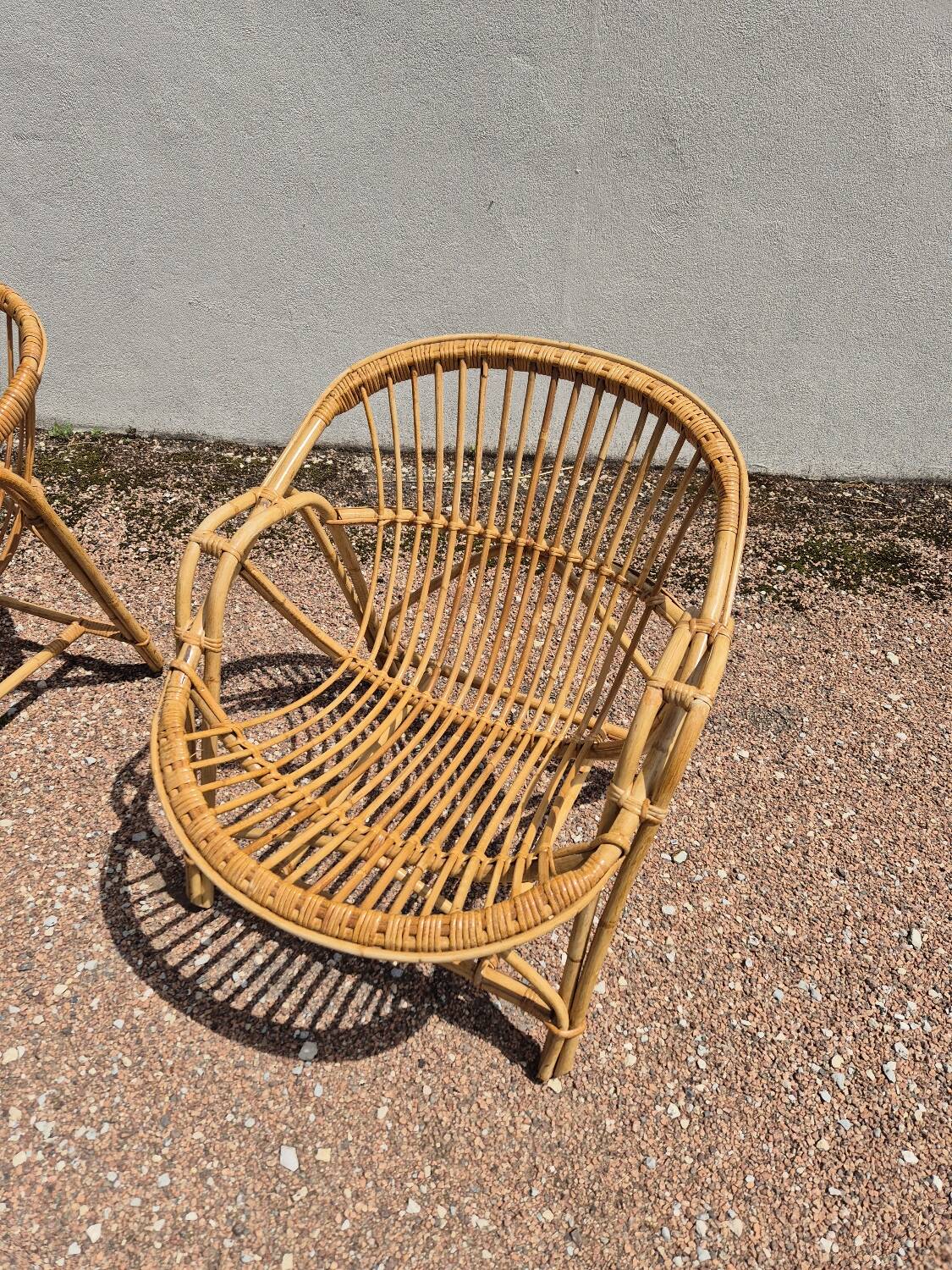 Rattan lounge with two armchairs and a vintage 1950s bench.