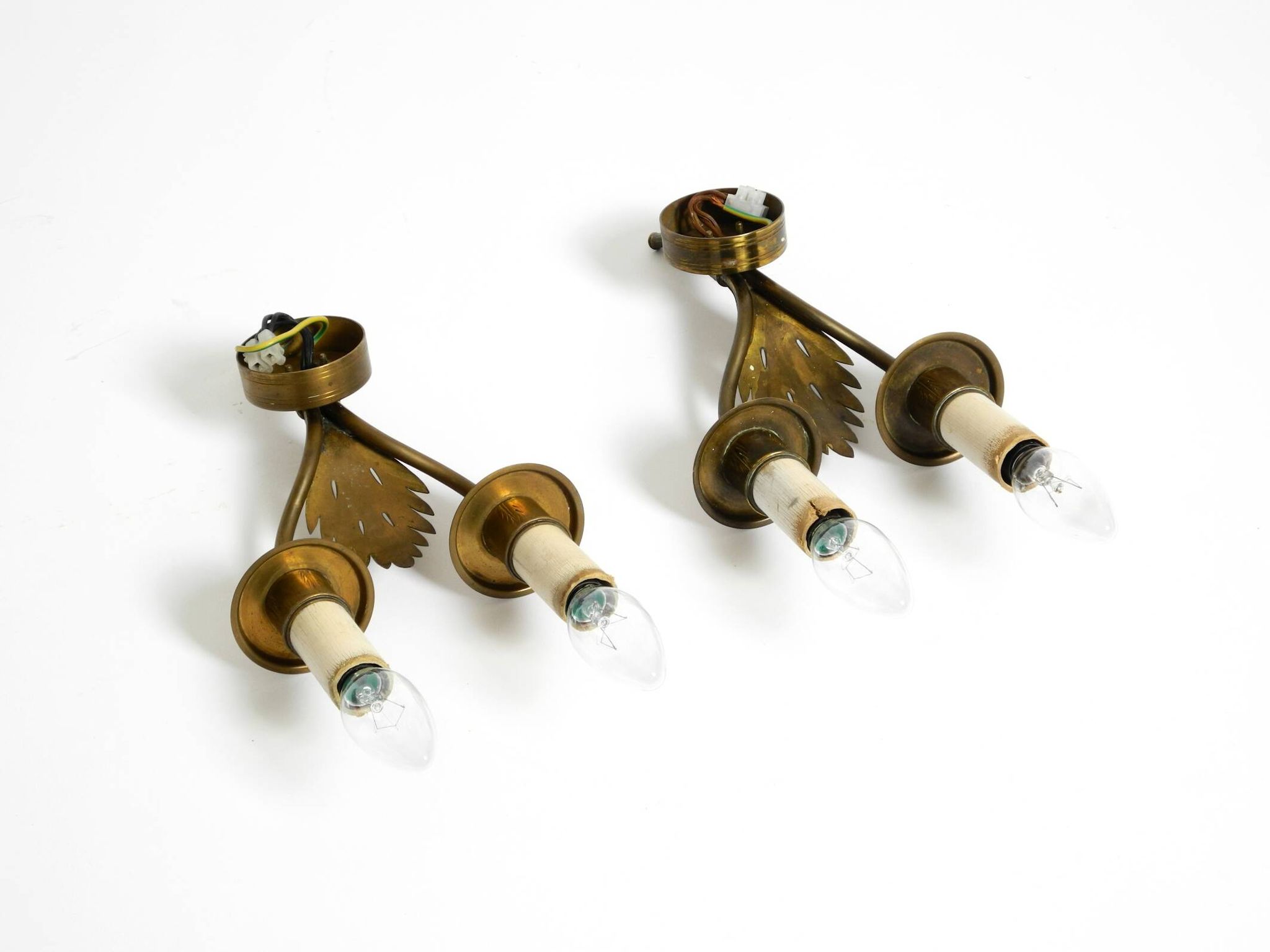 A pair of mid-century modern brass wall lamps by Vereinigte Werkstätten