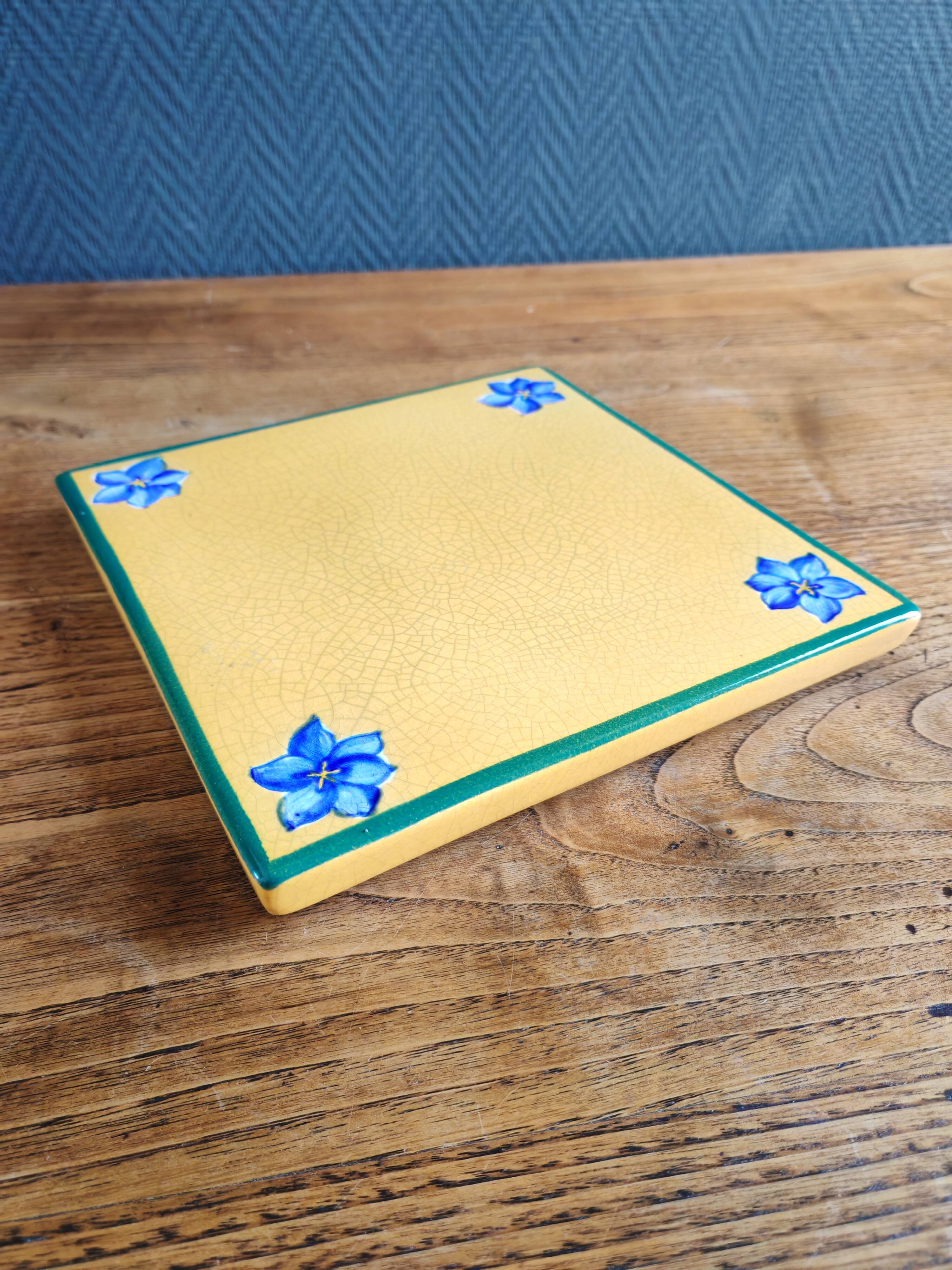 Yellow glazed ceramic trivet signed l. drimmer