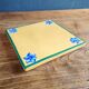 Yellow glazed ceramic trivet signed l. drimmer