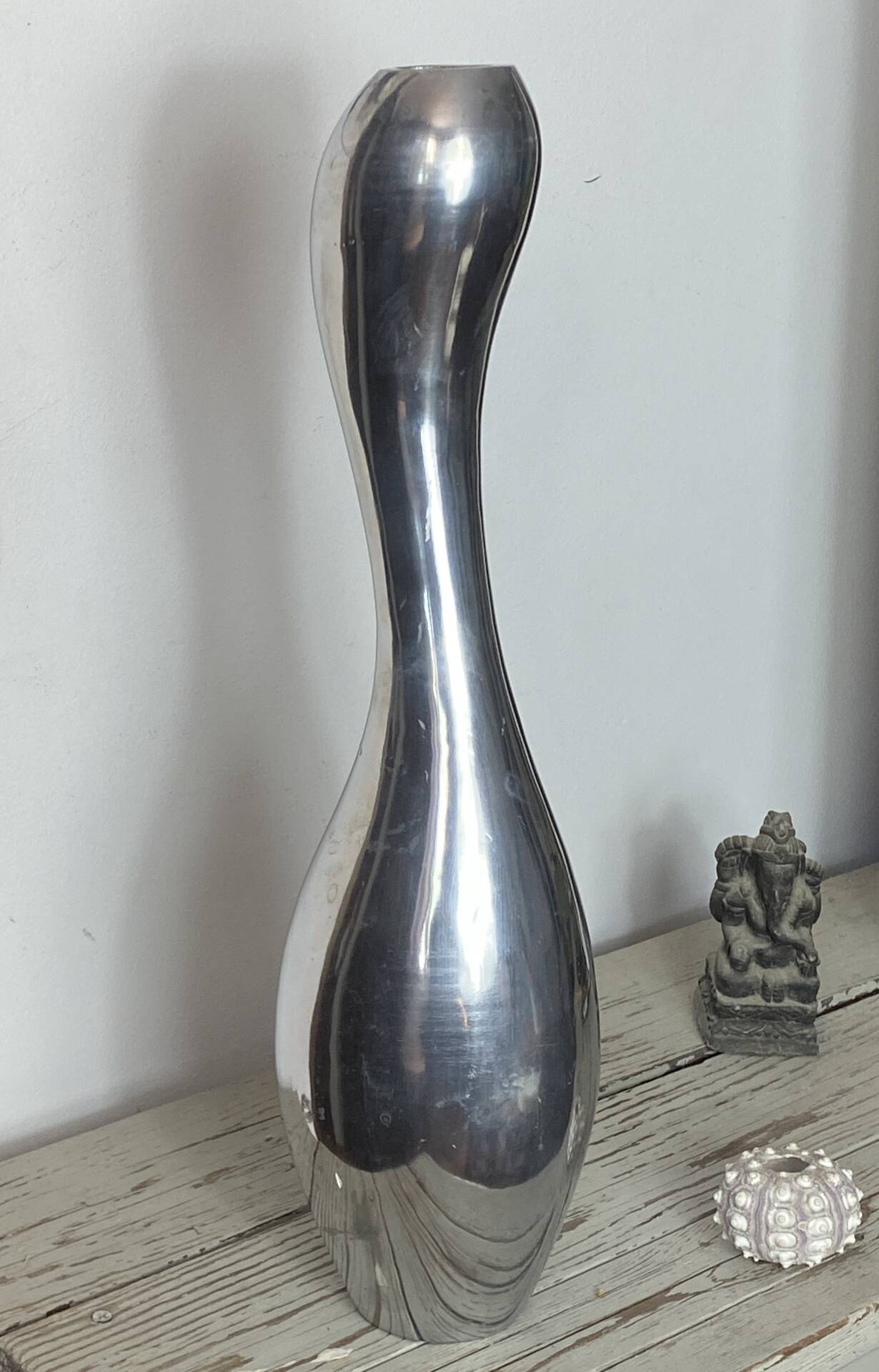 Large organic vase in polished aluminium cast.