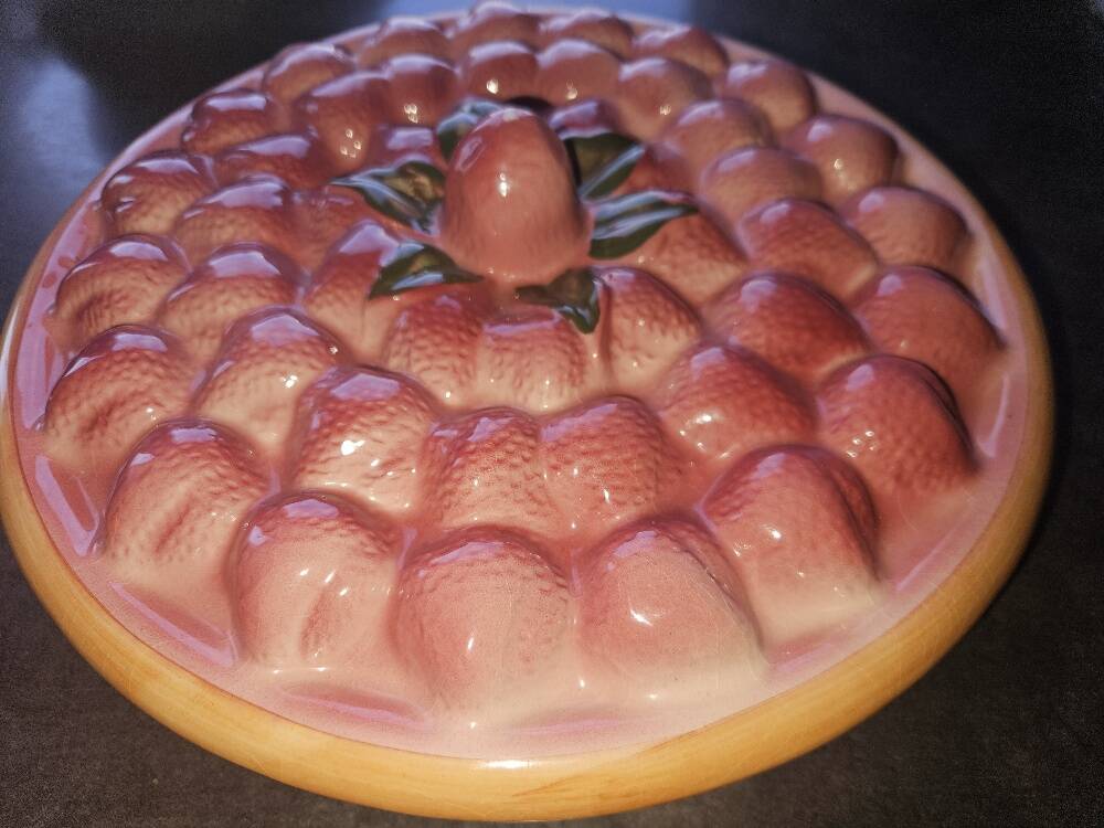 Glazed ceramic dessert plate with strawberry design.
