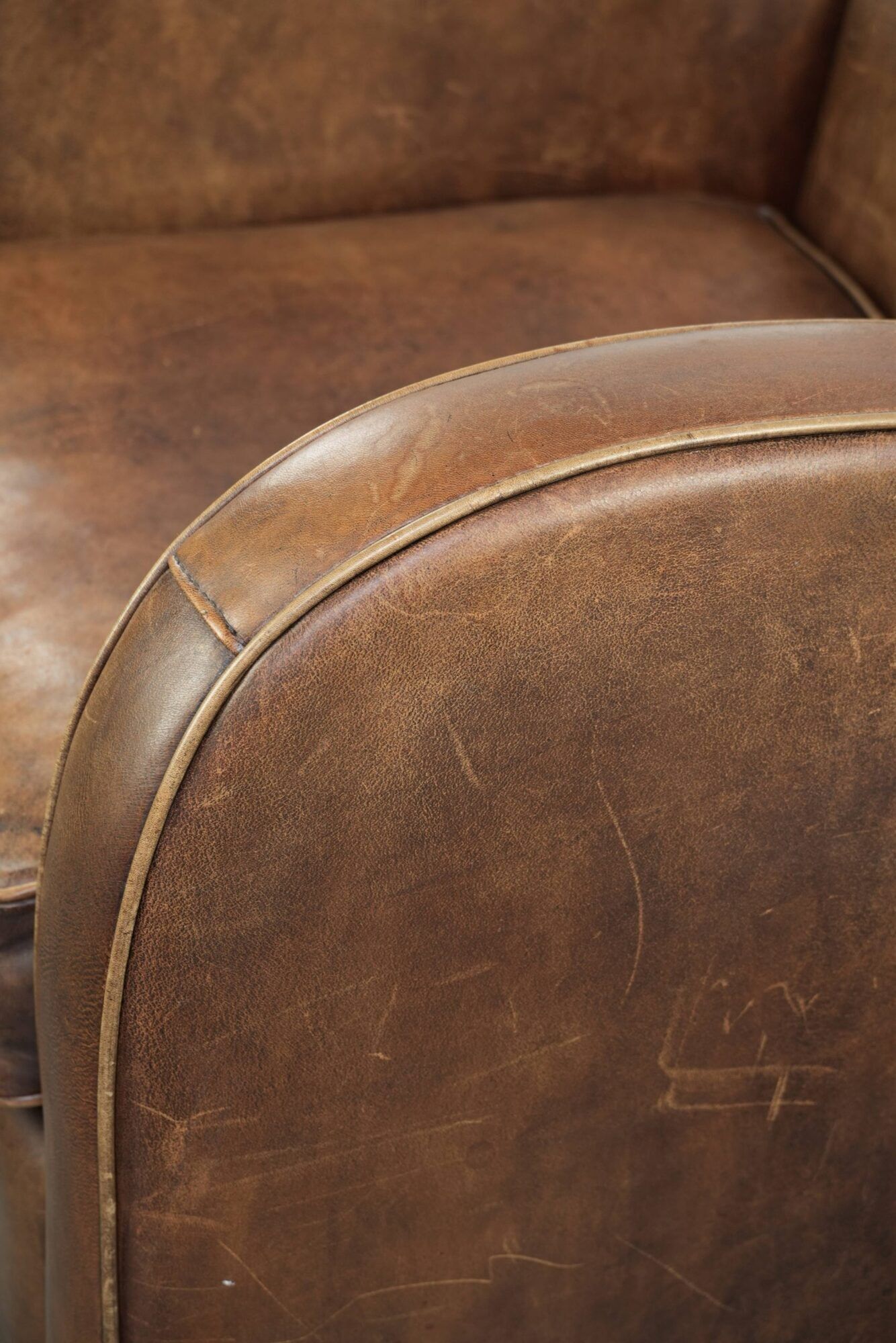 Sheepskin armchair in a light cognac colour with matching piping