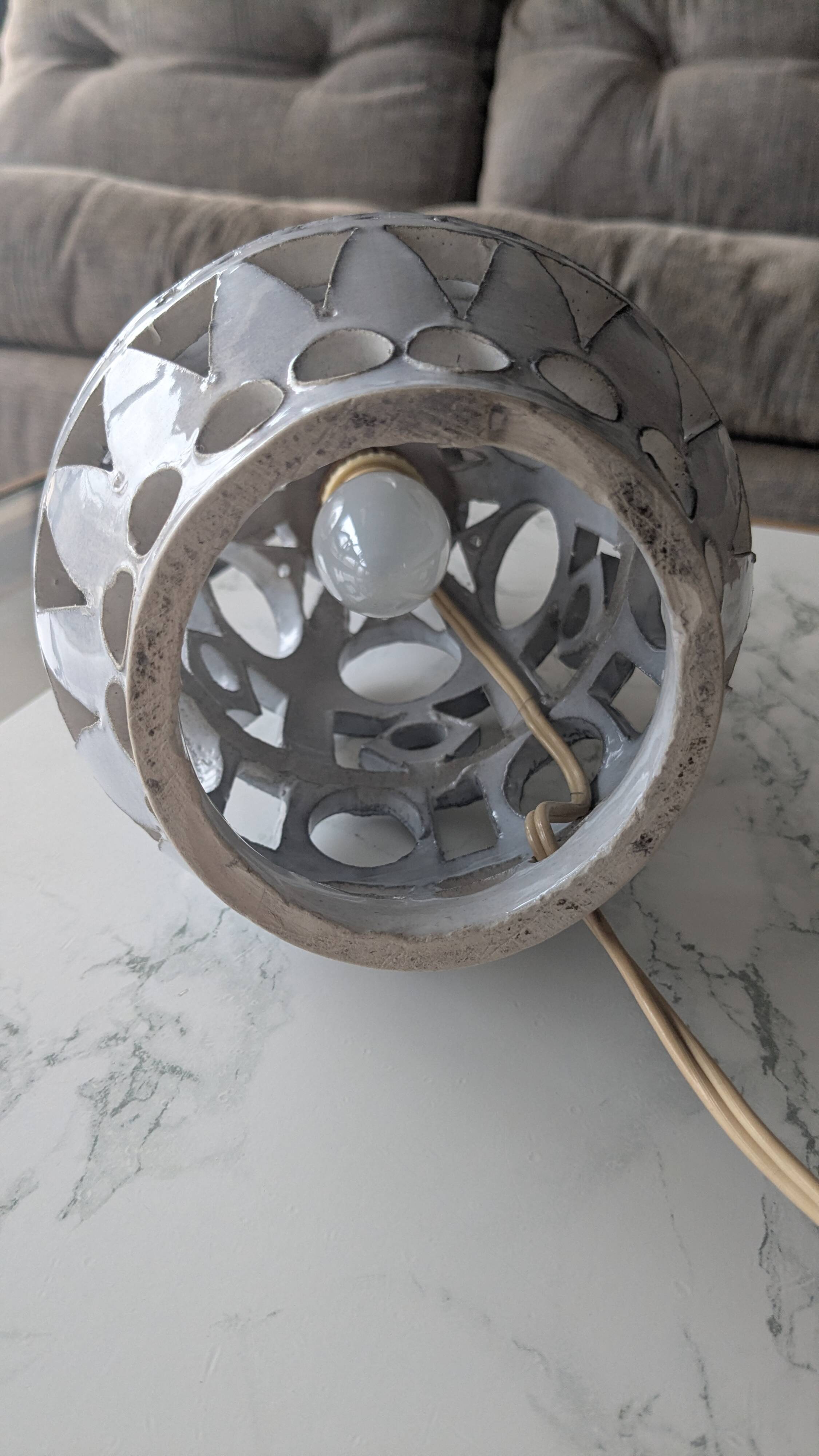 Ceramic lamp with cut-out design in the style of Roger Collet, 1960s.