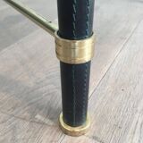 Brass coffee table upholstered in black leather. In the style of Jacques Adnet.