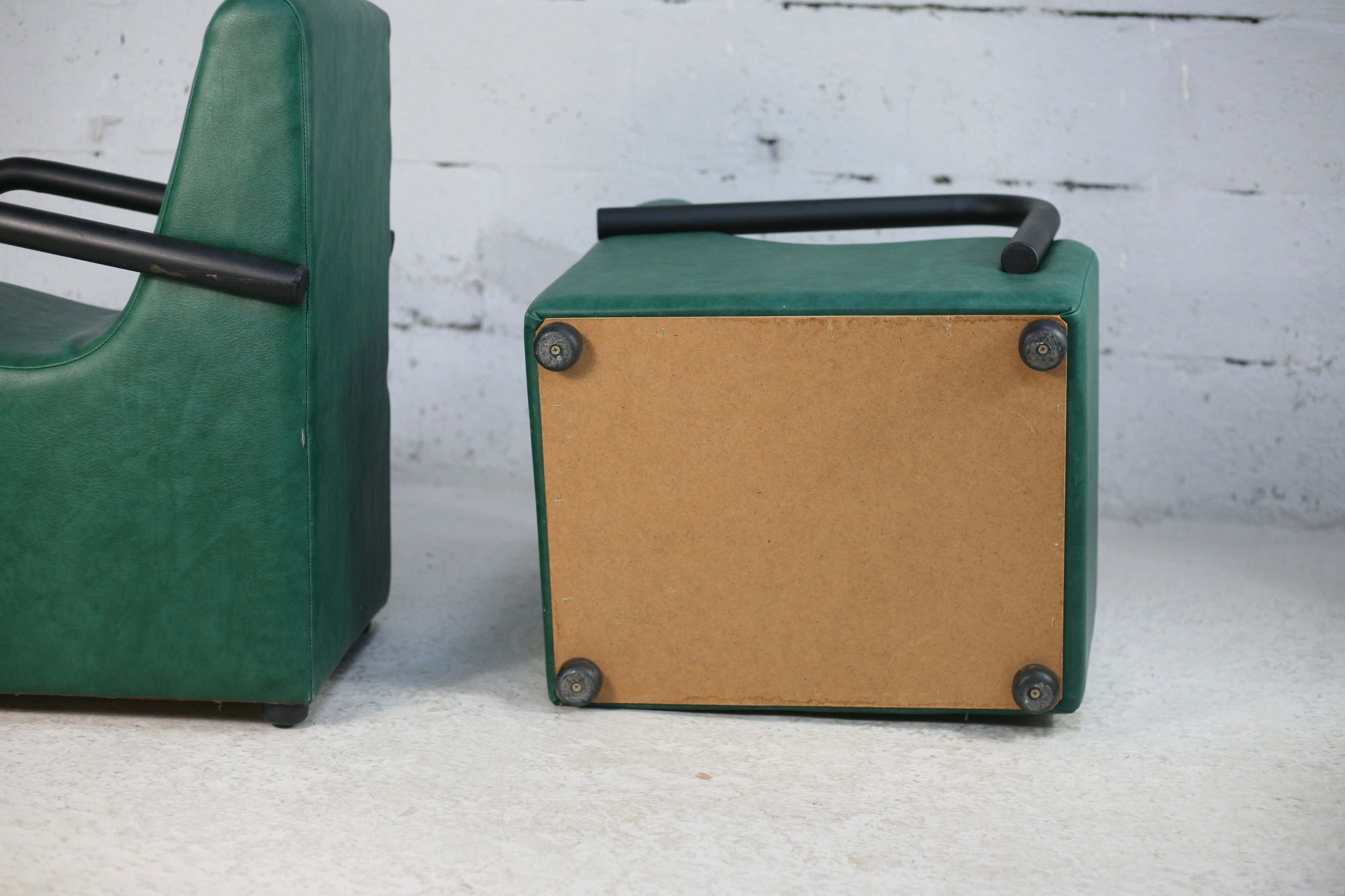 Pair of armrest heaters. Steel and green imitation leather. France, circa 1980