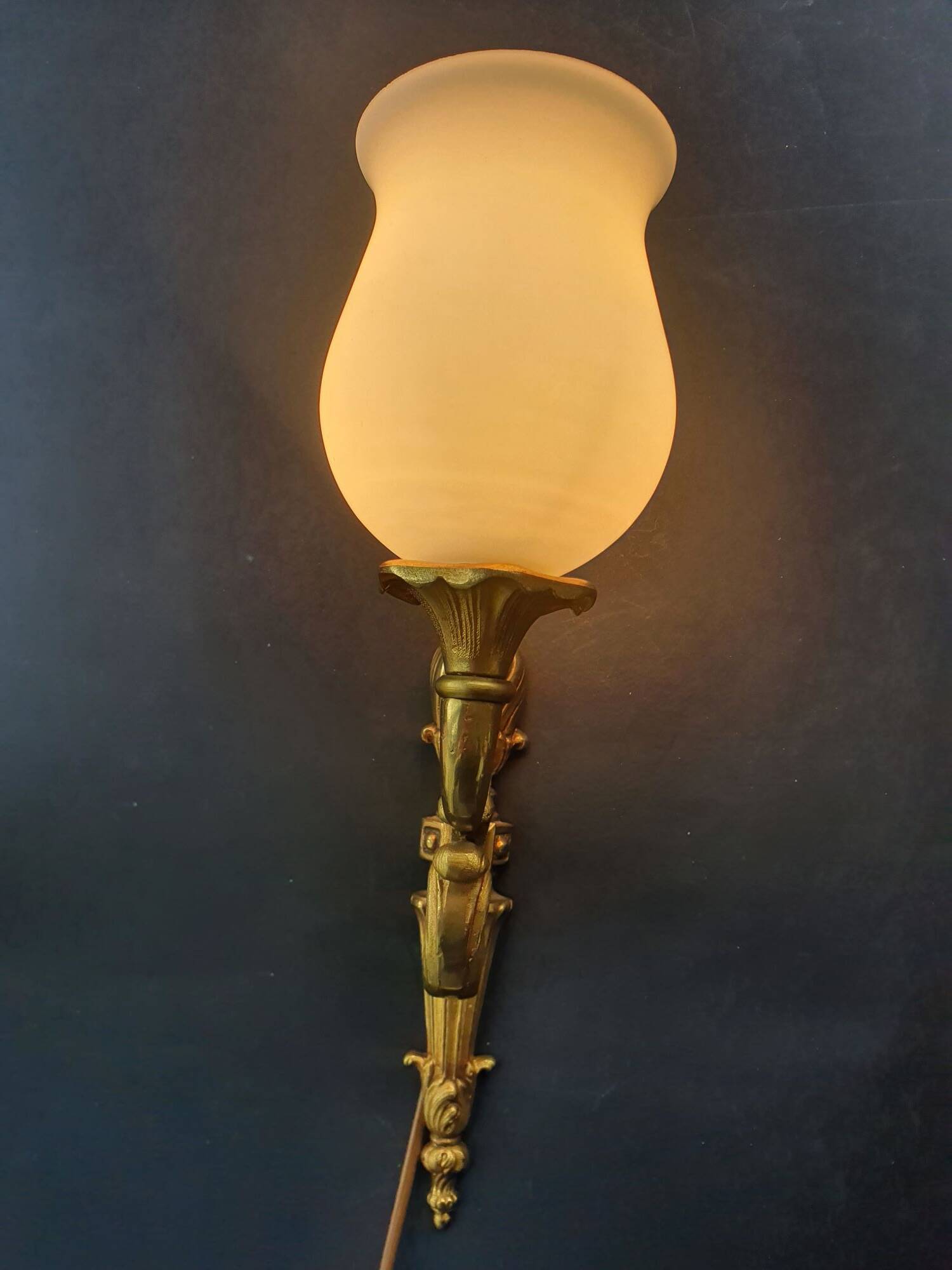 Three large vintage torch wall sconces.