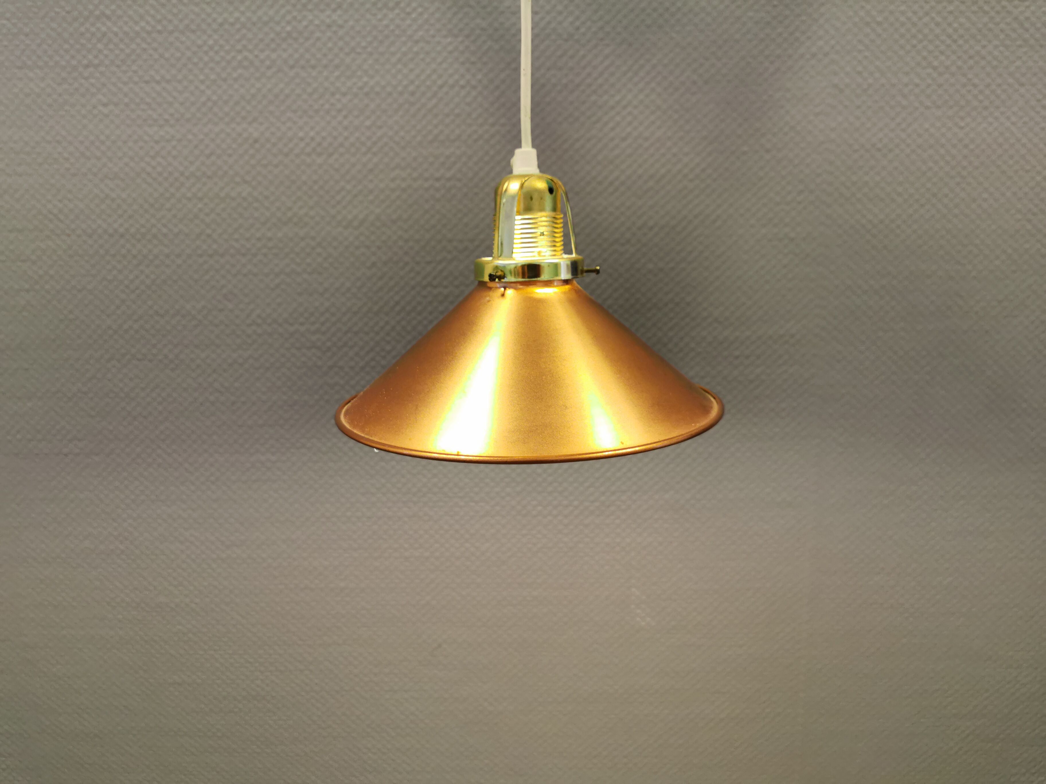 Copper hanging lamp with brass colored top and white inside lacquer.
