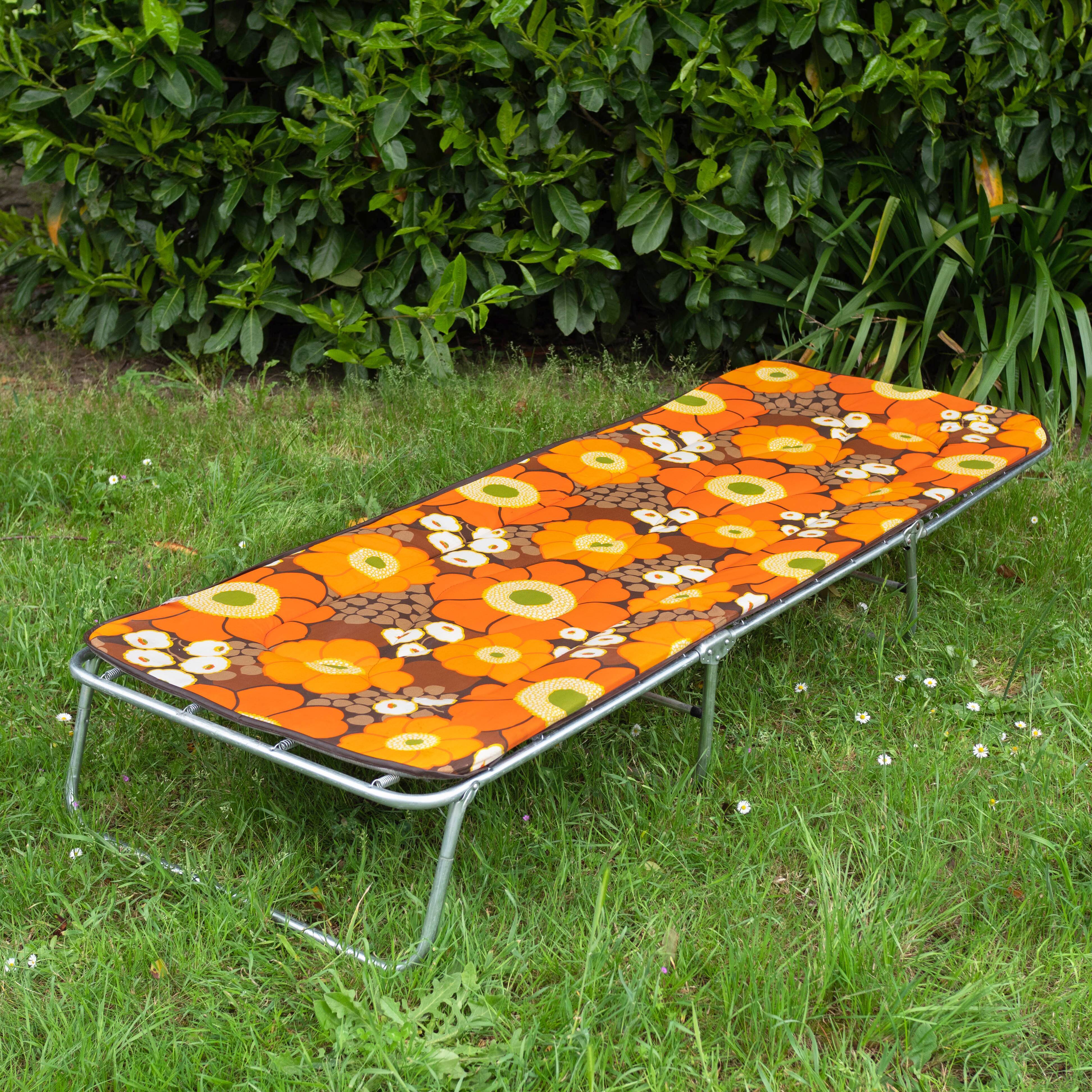 Vintage camp bed with orange flowers
