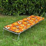 Vintage camp bed with orange flowers