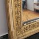 Golden stucco and wood Empire mirror