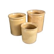 Trio of ancient pots in yellow glazed terracotta.
