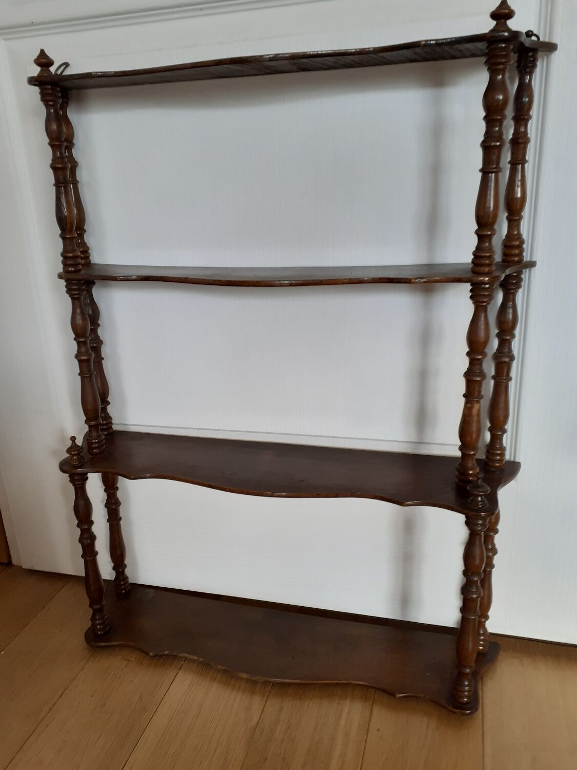 Turned wooden wall shelf