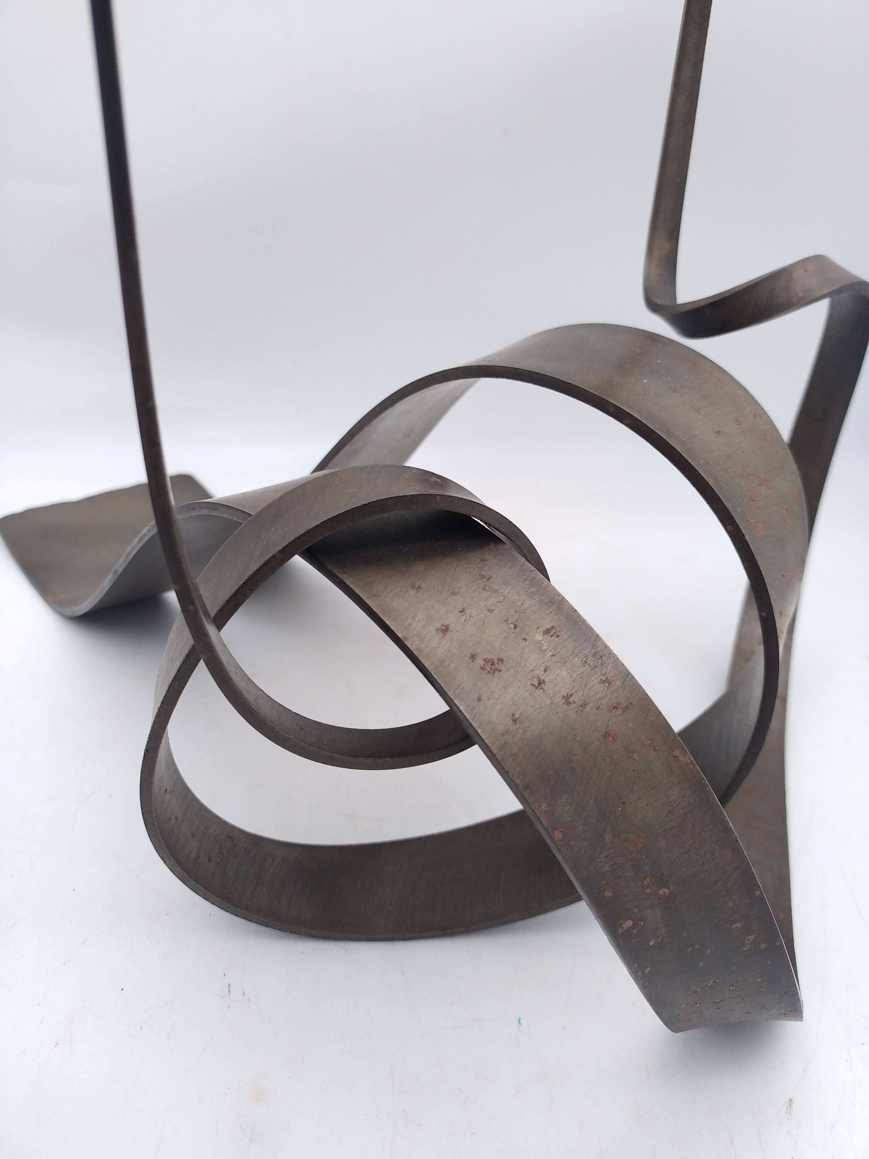 Brutalist candle holder in bronze effect metal.