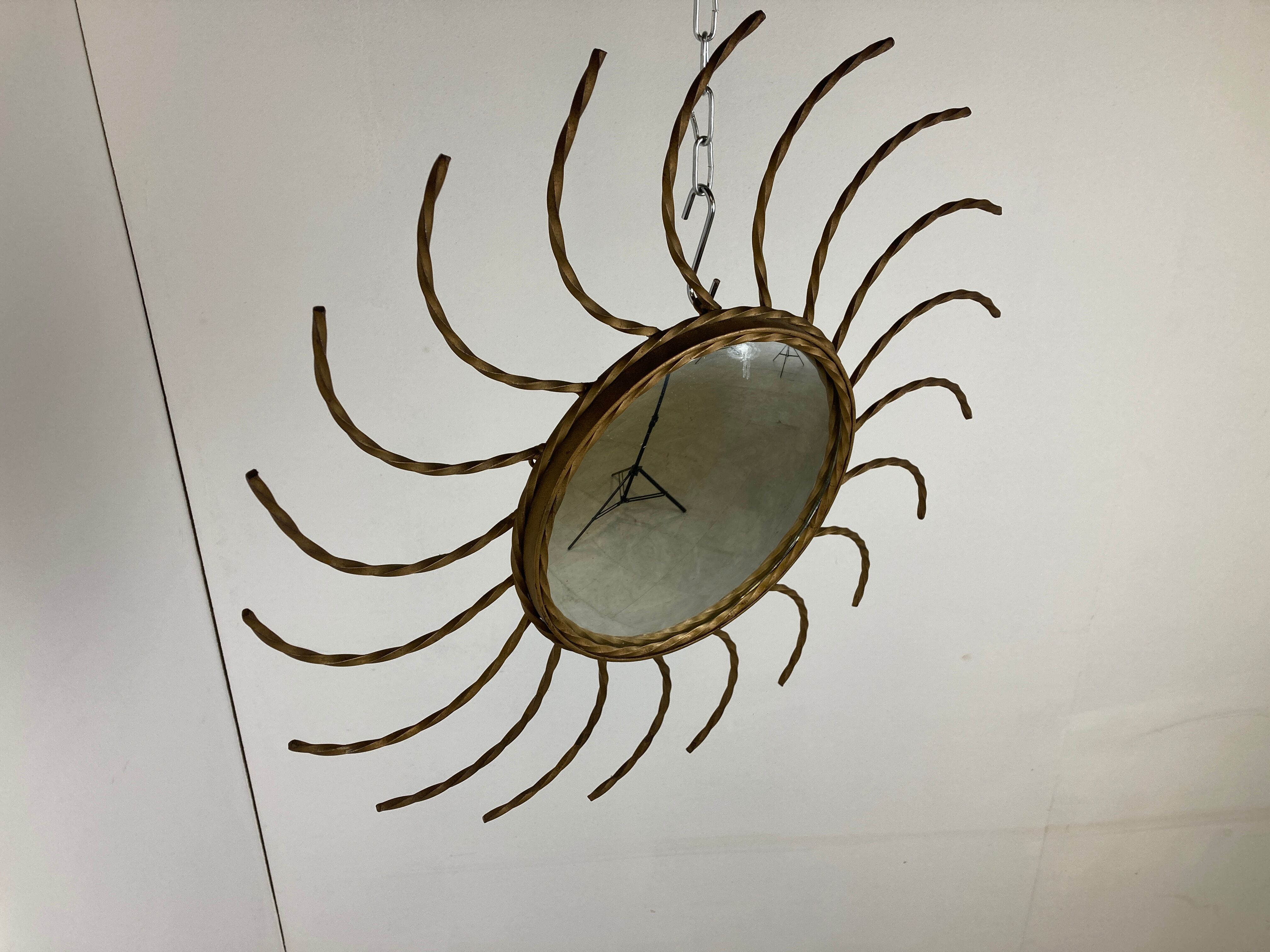 Mid century gold sunburst mirror with convex glass.