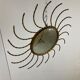 Mid century gold sunburst mirror with convex glass.