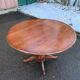 Round dining table, solid wood, central leg, extendable flaps, 20th century.