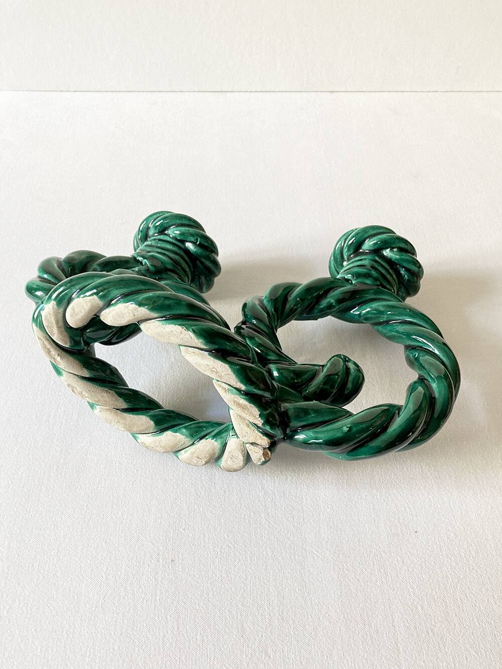 Two-armed candlestick in green glazed ceramic, braided effect