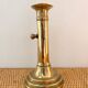 Old brass candlestick with push button.