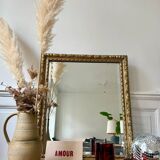 Bevelled mirror in carved gilded wood