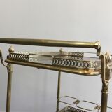 Neoclassical style rolling table in brass with blue glass tops
