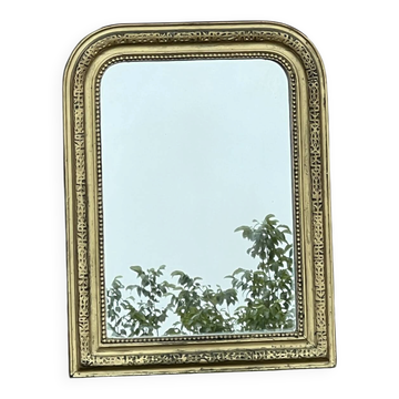 Louis Philippe mirror in gilded wood with an openwork frieze.