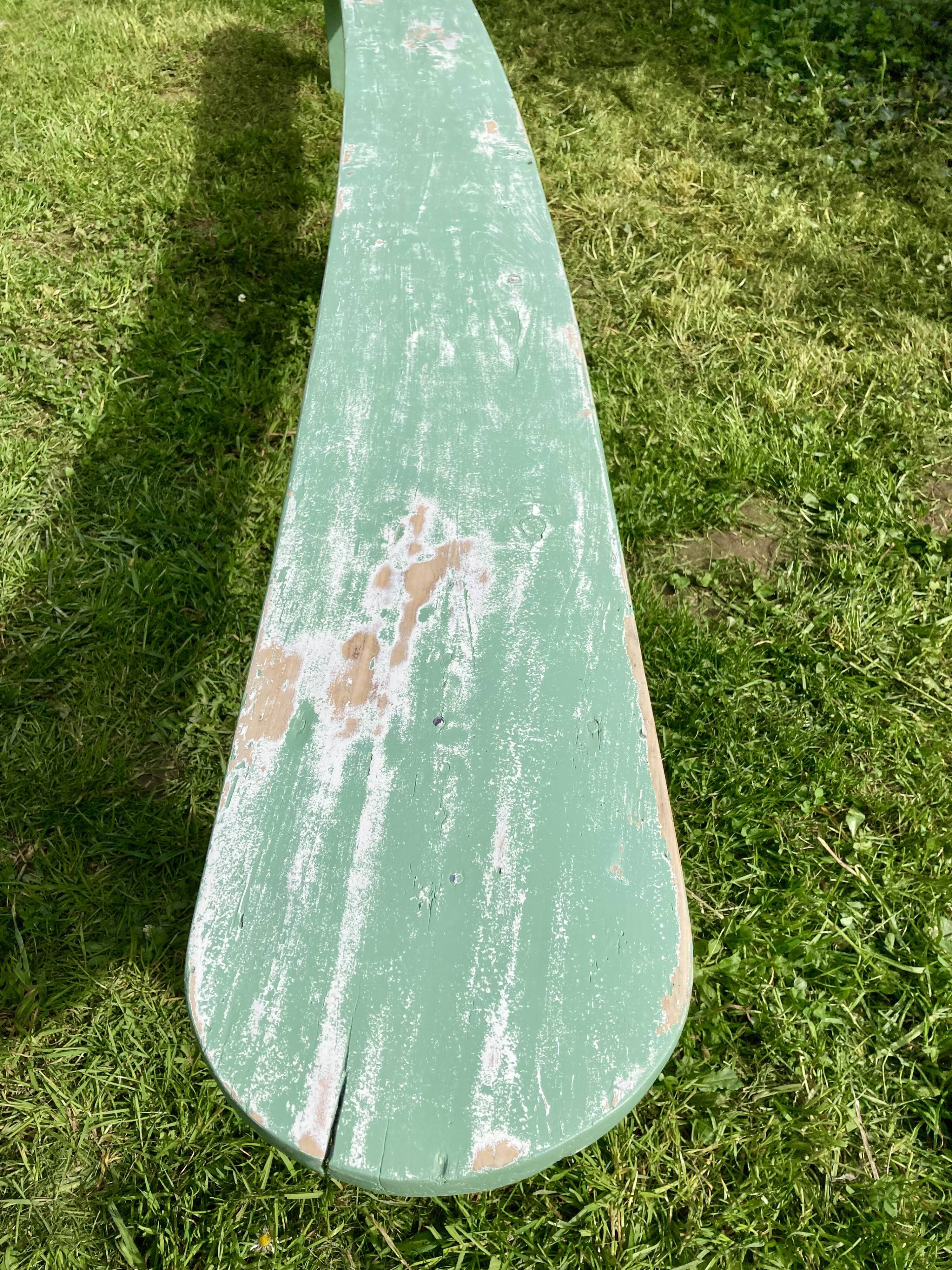 Old curved wooden farm bench