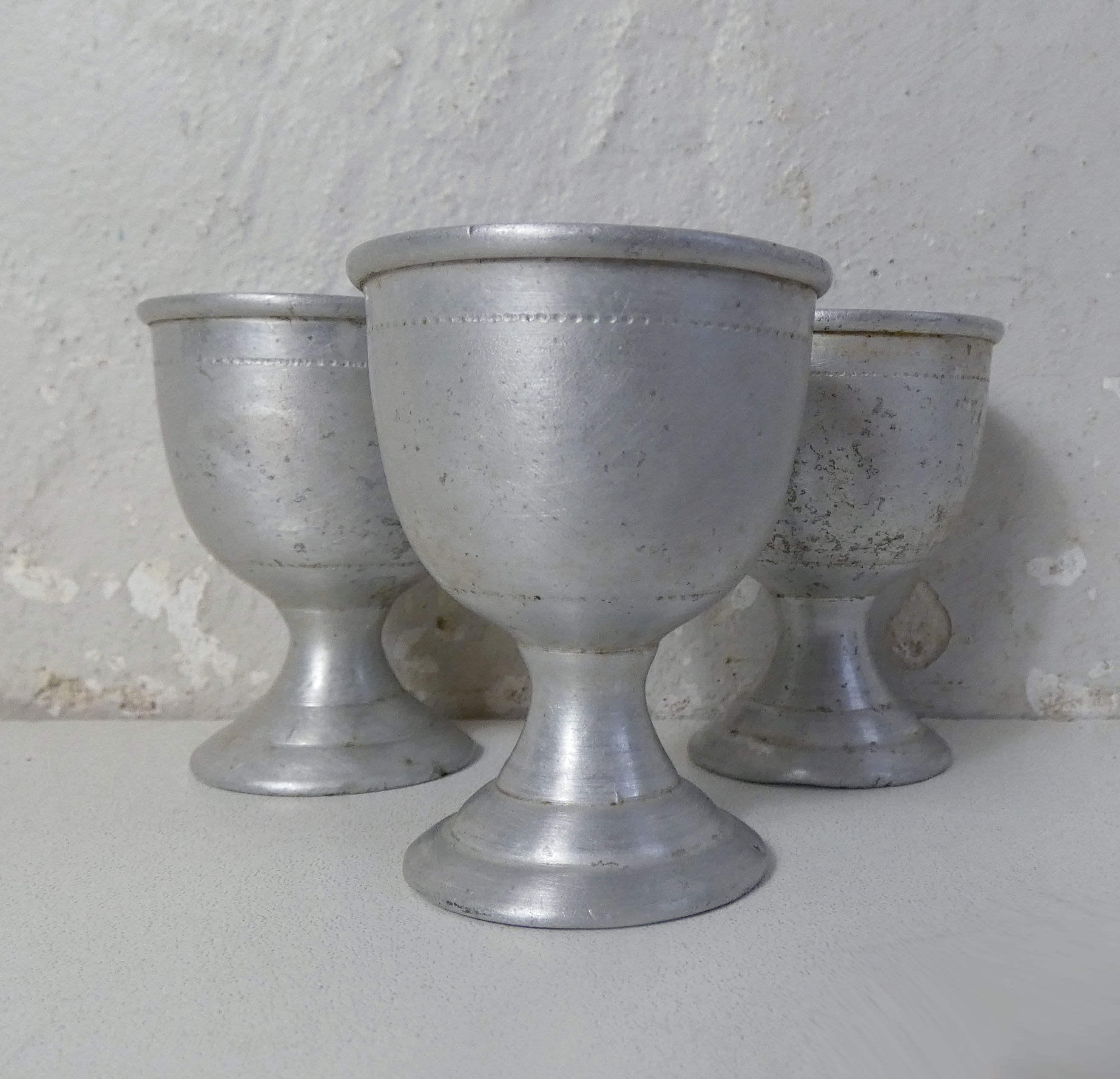 3 old aluminum shells