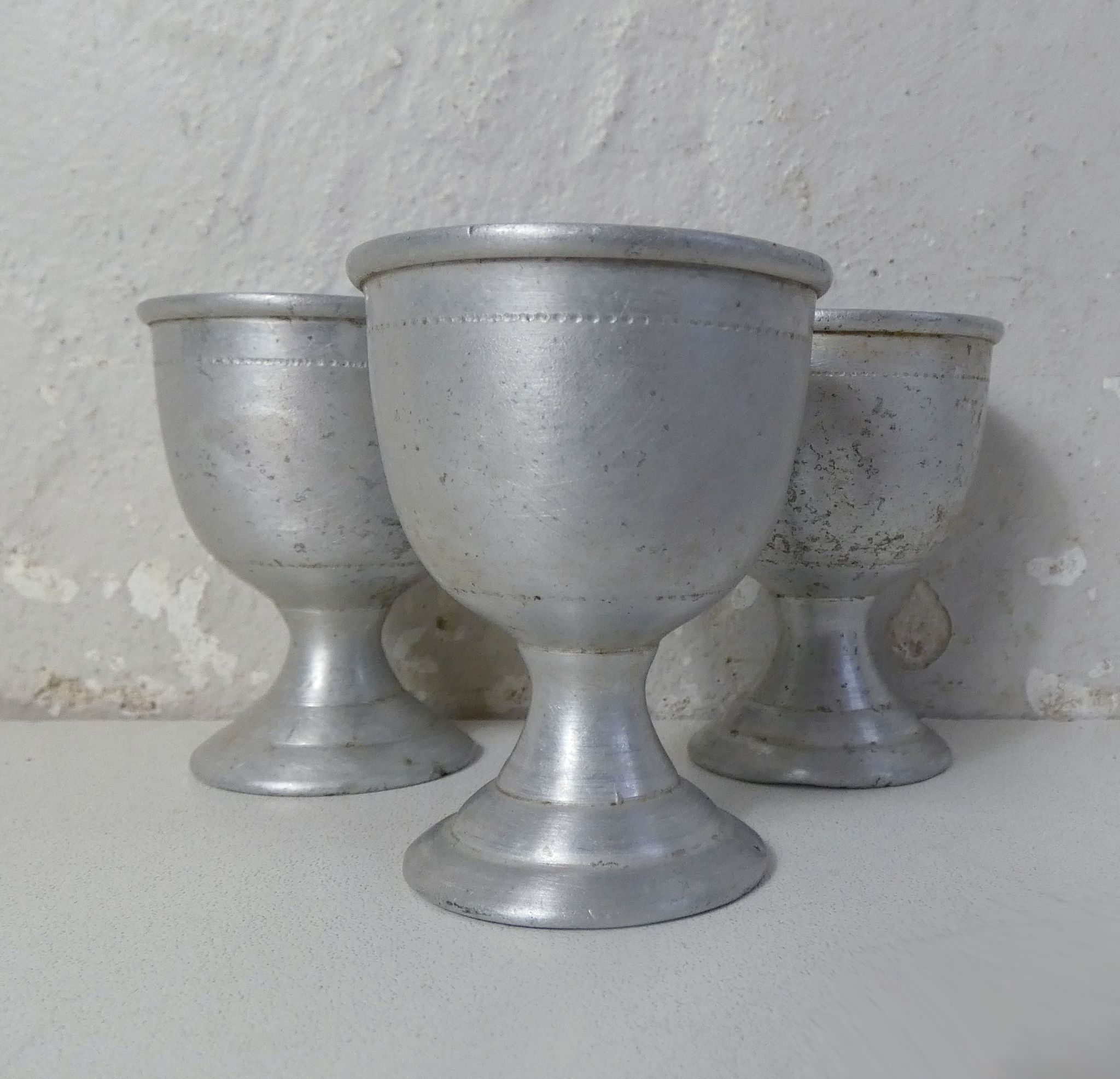 3 old aluminum shells