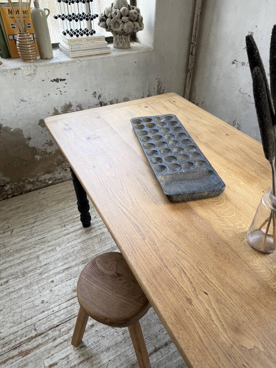 Oak farmhouse table with turned black legs.