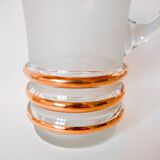 set composed of a pitcher and two large white granite glasses with gold edging from the 60s