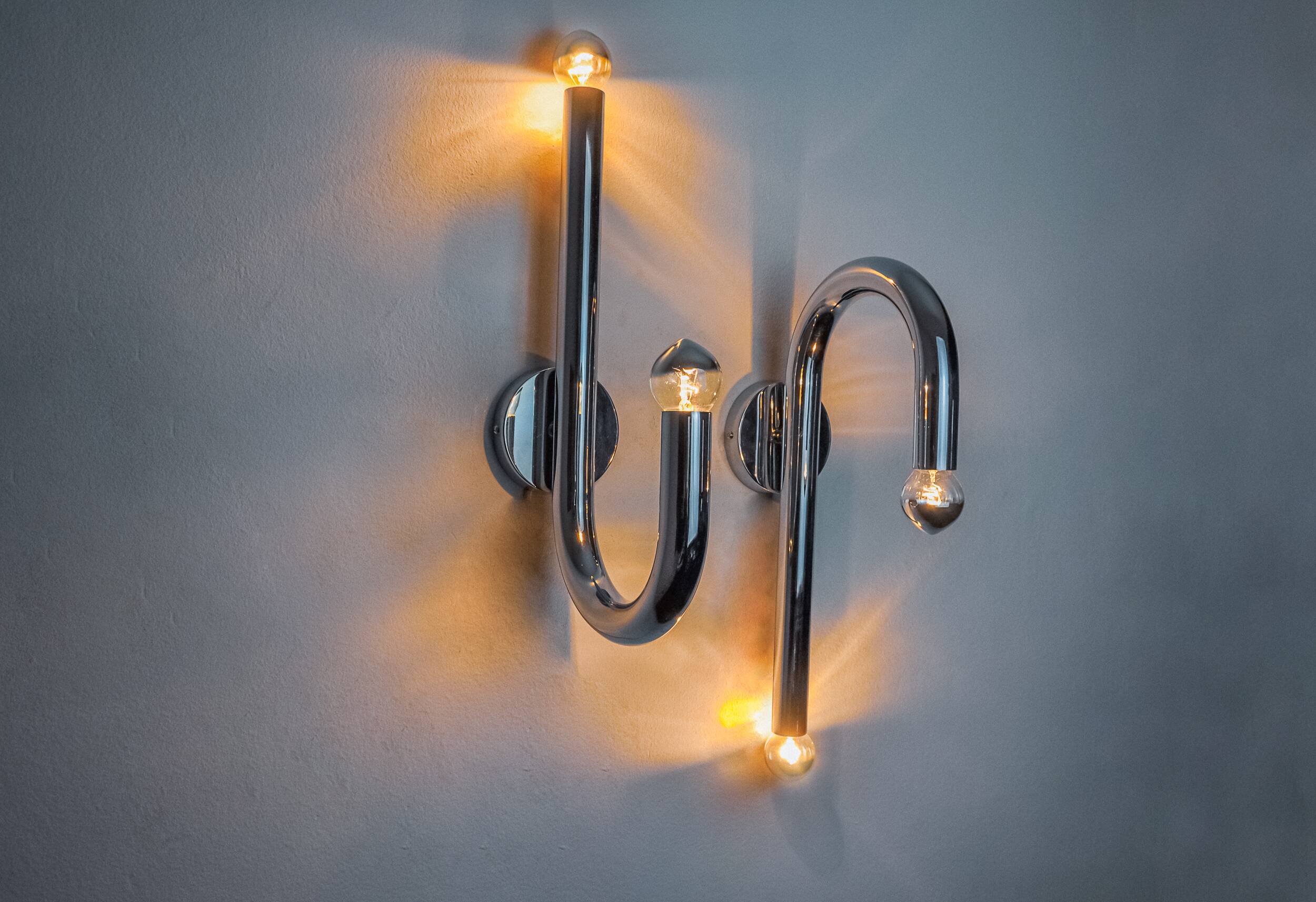 Pair of space-age tubular wall lights, chromed metal, Italy, 1970