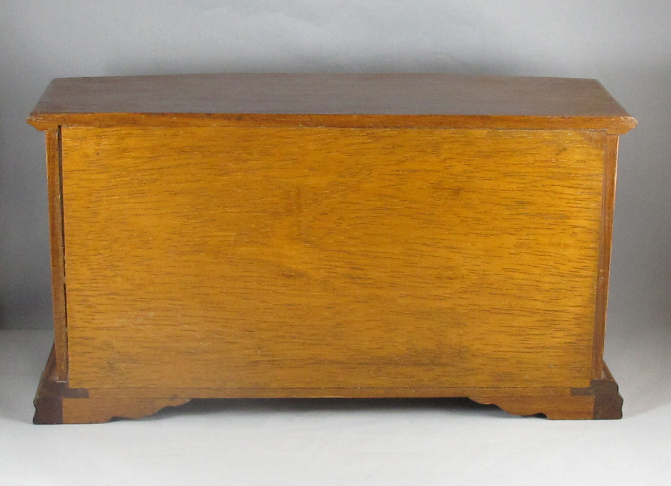 Wooden jewelry box in the shape of a chest of drawers