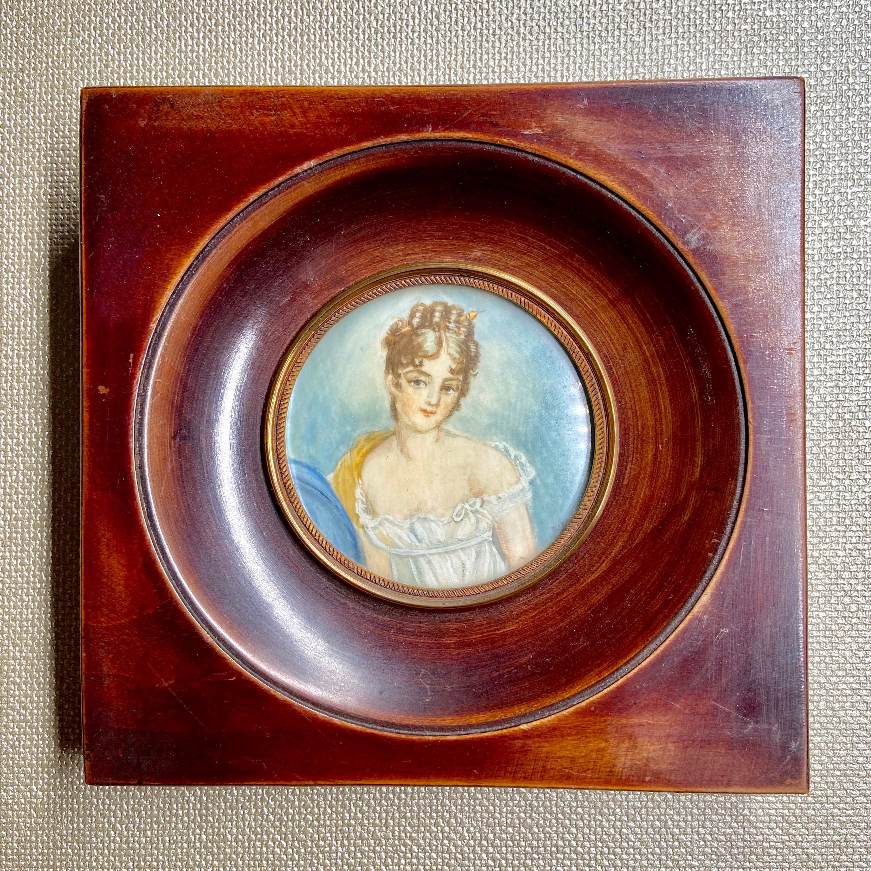 Miniature female portrait in wooden and brass frame