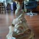 Glass table with carved wooden legs featuring intertwined fish.