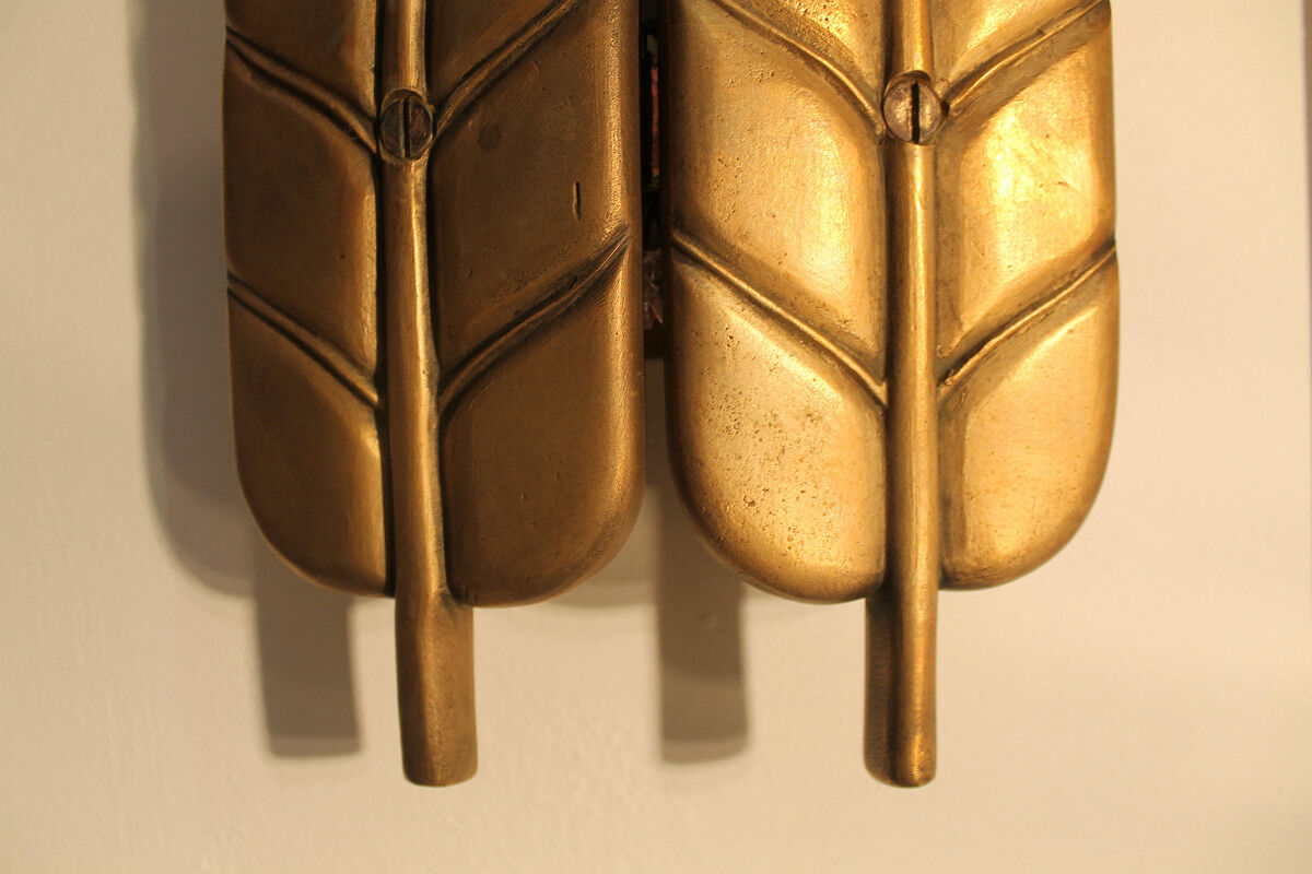 Applies in bronze "feathers"