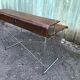 Design desk in formed glued laminated wood with chrome tubular base.